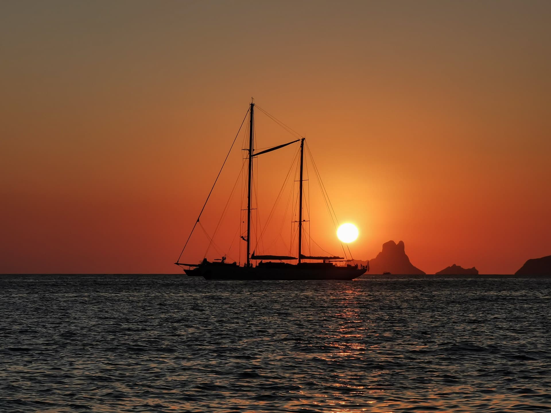 Red sunset with sailing yacht